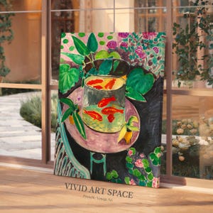 May include: A painting of a bowl of goldfish on a table with green plants and flowers. The bowl is clear and the goldfish are orange. The table is pink and white. The background is black.