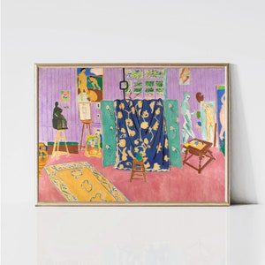 May include: A painting depicting an artist's studio with a blue and yellow patterned curtain, a wooden easel, and a small table with a vase of flowers. The walls are a light purple colour and the floor is a pink colour.