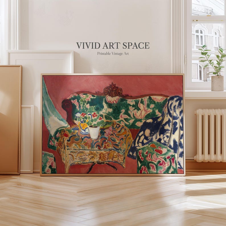 May include: A framed print of a vintage painting depicting a sofa and table with floral patterns. The artwork has a red background and includes the text "VIVID ART SPACE Printable Vintage Art". The sofa is green with red and pink floral designs.