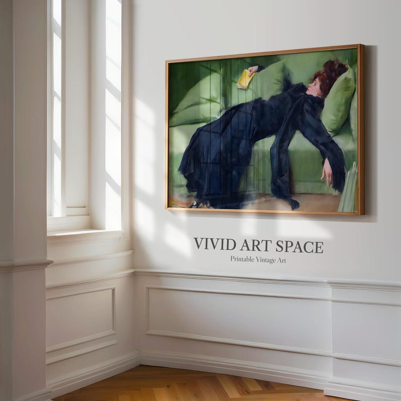 May include: A framed vintage art print depicting a woman in a black dress resting on a green sofa. The artwork has a gold frame and is displayed on a white wall. The text "VIVID ART SPACE" is printed below the artwork.