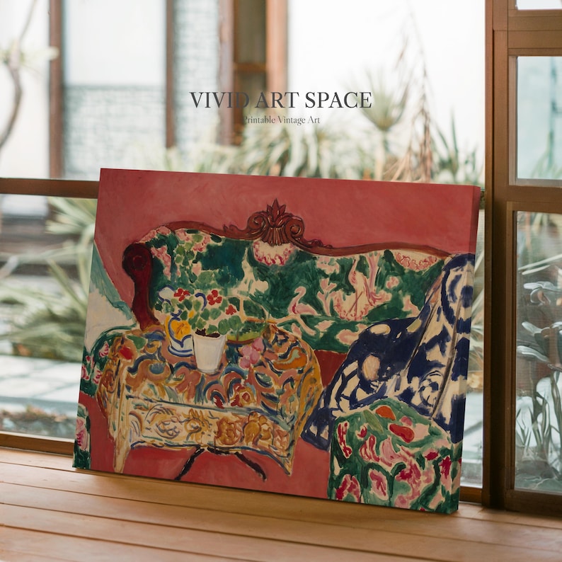 May include: A canvas print depicting a vibrant interior scene with a sofa and table. The sofa is decorated with green floral patterns, and the table holds a vase of flowers. The background is a soft pink, with the text "VIVID ART SPACE" and "Printable Vintage Art".