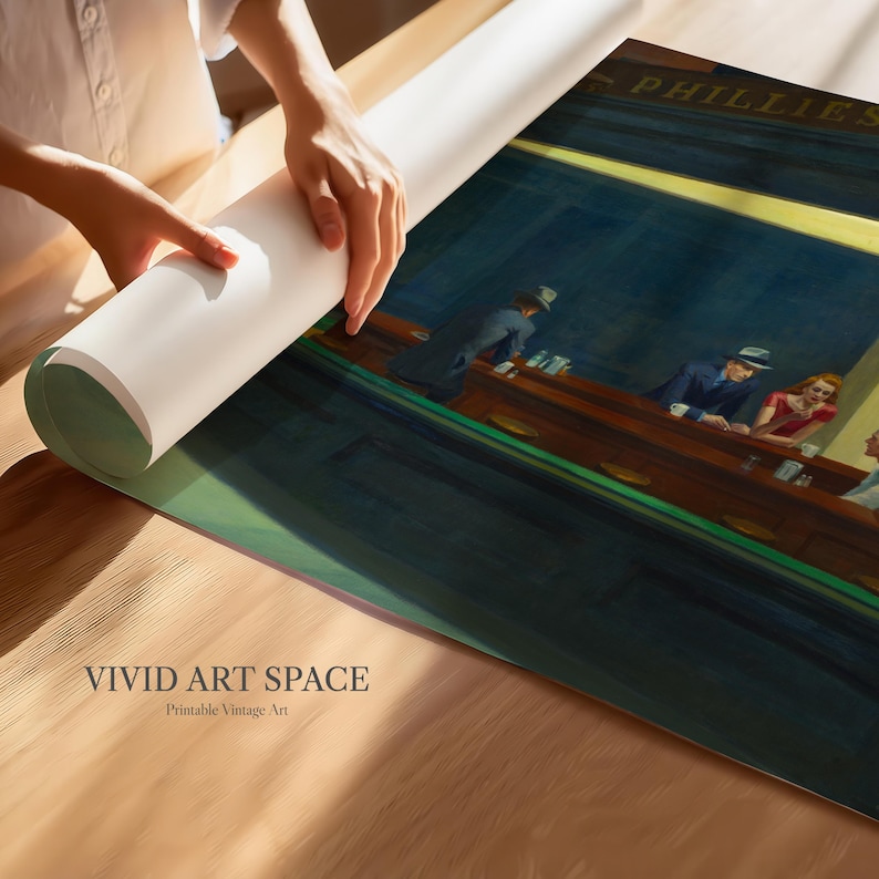 May include: A rolled-up art print featuring a vintage painting of a diner scene with people at the counter. The print is being unrolled on a wooden surface. The text "VIVID ART SPACE" and "Printable Vintage Art" are visible.