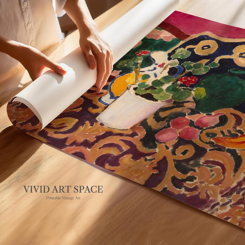 May include: A person unrolling a rolled-up art print featuring a still life painting. The artwork displays a vase of flowers, fruits, and a patterned background in shades of red, green, yellow, and purple. The text "VIVID ART SPACE Printable Vintage Art" is visible.