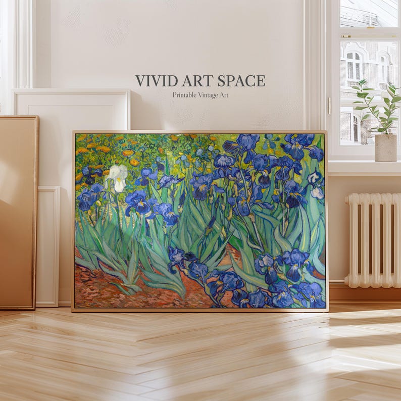 May include: A framed print of a floral painting featuring blue irises and other flowers. The artwork, in a wooden frame, is labeled "VIVID ART SPACE Printable Vintage Art". The painting has a vibrant color palette with green, blue, yellow, and white hues.