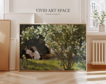 May include: A framed vintage art print featuring a serene outdoor scene. The artwork depicts a person relaxing in a chair under a flowering bush. The print has a wooden frame and the text "VIVID ART SPACE" is visible at the top.
