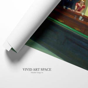 May include: A rolled canvas print of Edward Hopper's "Nighthawks" painting. The artwork depicts a diner scene with three patrons at the counter. The canvas is partially unrolled, revealing the artwork and the "VIVID ART SPACE" logo.
