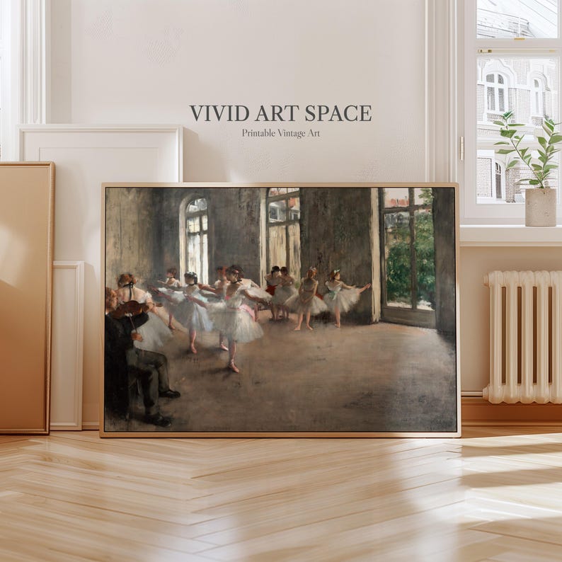 May include: A framed vintage print of a ballet rehearsal scene. The artwork depicts ballerinas in white tutus and a violinist in a dimly lit room. The text "VIVID ART SPACE Printable Vintage Art" is at the top.