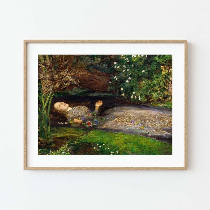 K&ouml;nnte beinhalten: Gerahmter Kunstdruck, der eine Frau zeigt, die in Wasser treibt, umgeben von Gr&uuml;n und Blumen. Das Kunstwerk verwendet ged&auml;mpfte Farben, darunter Gr&uuml;n, Braun und Wei&szlig;, wodurch eine ruhige und melancholische Atmosph&auml;re entsteht. Der Rahmen ist aus hellem Holz.