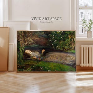 May include: A framed print of a painting depicting a woman in a stream, surrounded by foliage and flowers. The artwork has a vintage style, with the text "VIVID ART SPACE Printable Vintage Art" at the top.