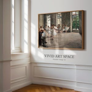May include: A framed print of a ballet rehearsal scene. The artwork depicts dancers in white tutus and a man playing a violin. The print is in a wooden frame and hangs on a white wall. The text "VIVID ART SPACE" is printed below the frame.