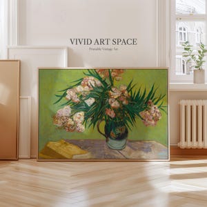 May include: A framed vintage art print featuring a still life of flowers in a vase, with a book on a table. The artwork has a green background and the text "VIVID ART SPACE Printable Vintage Art" at the top.