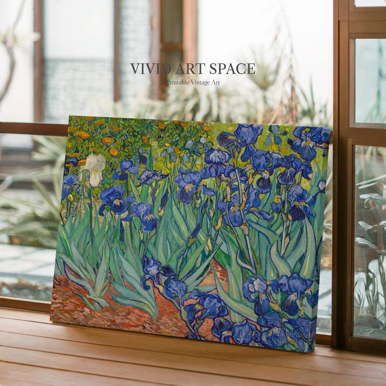 May include: A canvas print of a floral painting featuring blue irises and green foliage. The artwork, with the text "VIVID ART SPACE Printable Vintage Art", is displayed near a window, showcasing a classic art style.