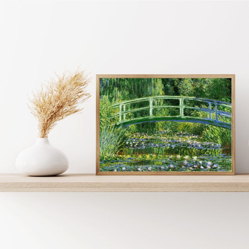 May include: A painting of a green bridge over a pond with water lilies. The bridge is made of wood and has a white railing. The pond is surrounded by green trees and bushes. The water is a light blue color and there are white water lilies floating on the surface.