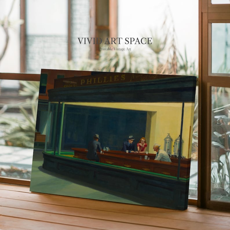 May include: A canvas print of Edward Hopper's "Nighthawks" painting. The artwork depicts a diner scene with four figures under bright lights. The diner's name, "PHILLIES", is visible above the awning. The print is displayed on a wooden surface.