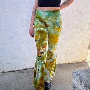 May include: Green, brown, and white tie-dye bell bottom pants with a high waist.