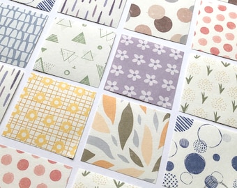 May include: A collection of 12 patterned paper squares with various designs, including geometric shapes, flowers, leaves, and dots. The papers are in a variety of colors, including yellow, blue, green, pink, and purple.