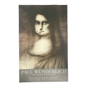 May include: A black and white poster advertising an art exhibition of watercolors and lithographs by Paul Wunderlich at Galerie Berggruen in Paris, France. The poster features a close-up portrait of a woman with a Mona Lisa-like smile.