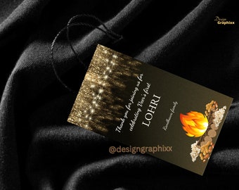 May include: A black tag with a string, featuring gold glitter and text. The tag reads "Thank you for joining us for celebrating Veer's first LOHRI" with a fire graphic and the text "Randhawa family" and "@designgraphixx".