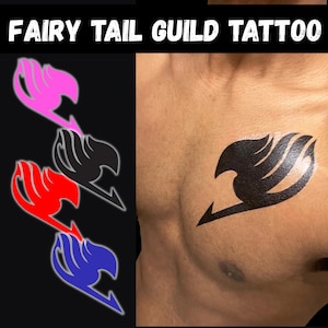 May include: A temporary tattoo featuring the Fairy Tail guild emblem in pink, black, red, and blue. The text FAIRY TAIL GUILD TATTOO is displayed at the top. The black emblem is shown applied to a chest, demonstrating the design's appearance on skin.