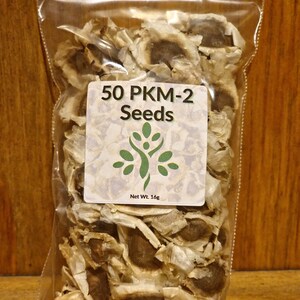 May include: A clear plastic bag filled with 50 brown moringa seeds. The bag has a white label that reads "50 PKM-2 Seeds" and "Net Wt. 16g".