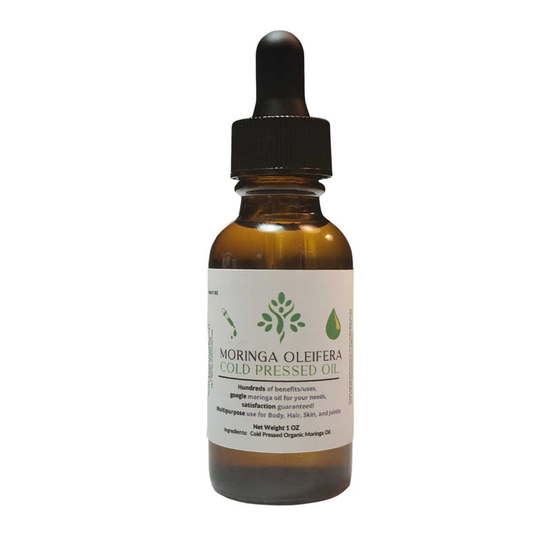 May include: A brown glass bottle with a dropper top filled with a clear liquid. The bottle label reads "Moringa Oleifera Cold Pressed Oil" and lists the net weight as 1 oz. The label also mentions that the oil is cold pressed organic moringa oil.