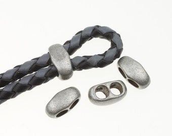 May include: Four silver-toned metal cord ends with two holes each. One cord end is threaded through a black braided leather cord.