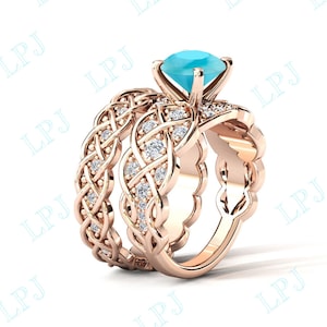 May include: A rose gold engagement ring set with a braided band and a large, light blue gemstone. The ring is set with smaller clear gemstones.