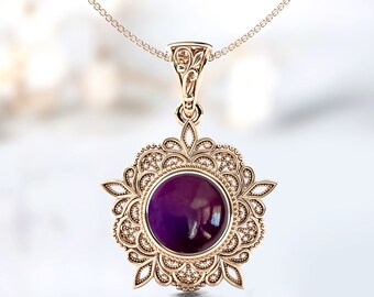 May include: A delicate gold pendant necklace with a purple gemstone set in a filigree design.