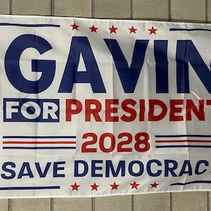 May include: White political campaign flag with blue and red text. The flag reads "Gavin for President 2028 Save Democracy" with stars in the corners.