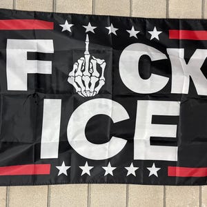 May include: Black flag with white text reading "F*CK ICE" and a skeleton hand giving the middle finger. The flag has red stripes and white stars.