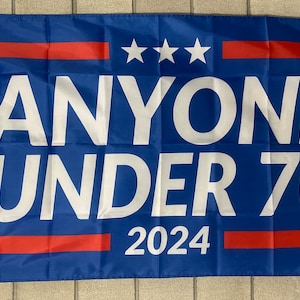 May include: A blue flag with white text that reads "ANYONE UNDER 70 2024". There are three white stars and two red stripes on the flag.