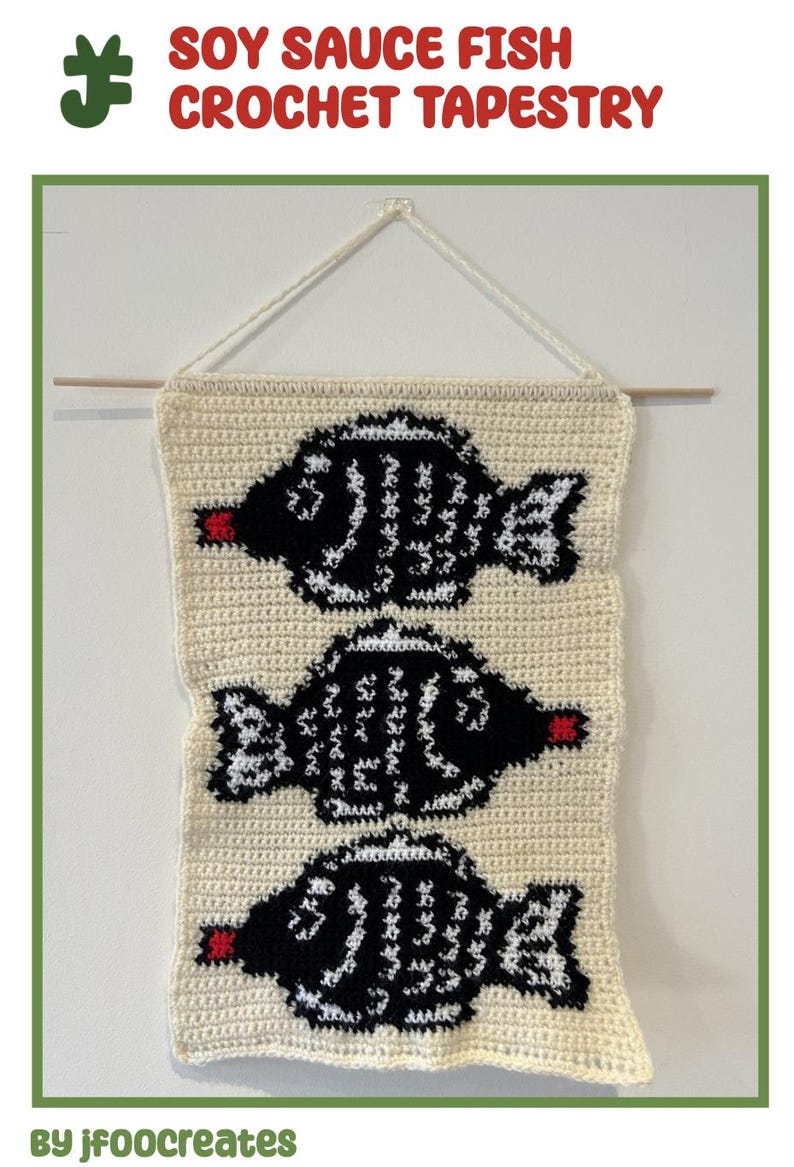 May include: A crocheted tapestry featuring three black and white fish with red mouths. The tapestry is hanging on a white wall with a wooden dowel rod. The text "SOY SAUCE FISH CROCHET TAPESTRY" is at the top of the image. The text "By jf00creates" is at the bottom of the image.