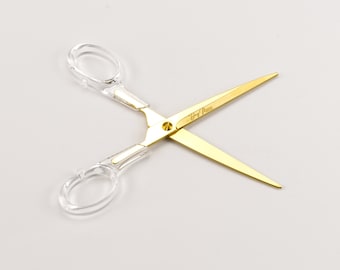 Gold acrylic scissors decorate every desk