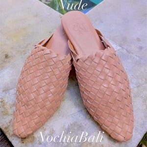 K&ouml;nnte beinhalten: Ein Paar nude farbene geflochtene Leder-Mules mit spitzer Zehenpartie. Die Schuhe sind aus weichem, geschmeidigem Leder gefertigt und haben eine bequeme Passform.