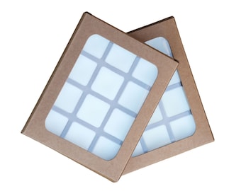 May include: Two brown cardboard boxes with clear plastic windows, each containing 16 square compartments.