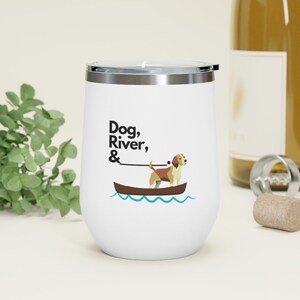 May include: White stainless steel wine tumbler with a black and white graphic of a dog in a boat on a blue river. The text "Dog, River, &" is printed on the tumbler.