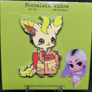 May include: A pin featuring a cartoon fox-like character in a yellow and orange kimono. The pin has a floral hair accessory and is set against a green background. The text "Porcelain Widow" and "seviyummy" are visible.