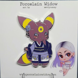May include: A pin featuring a cartoon Umbreon character in a kimono with a moon and star design. The pin has purple, yellow, and blue accents. The text "Porcelain Widow" and "seviyummy" are at the top, and "www.porcelainwidow.com" is at the bottom.