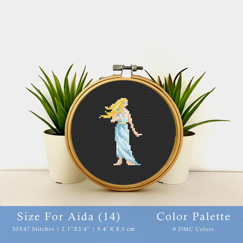May include: Cross stitch pattern of a woman with long blonde hair wearing a light blue dress. The pattern is displayed in a wooden embroidery hoop on a white surface. The pattern is 30 by 47 stitches and measures 2.1 inches by 3.4 inches. The pattern uses 9 DMC colors.