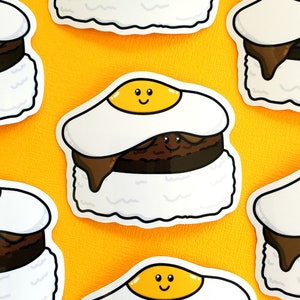 May include: Seven colorful stickers of a Hawaiian dish with a fried egg on top. The dish is made of rice, a hamburger patty, and a brown sauce. The egg has a smiley face on it.