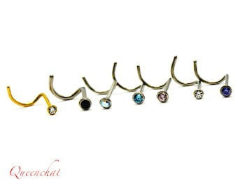 May include: A set of ten nose rings featuring various coloured gemstones. The rings are crafted from surgical steel and come in a range of colours, including clear, black, blue, pink, and purple.