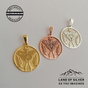 May include: Three gold-plated and silver pendants featuring a moth design. Each circular pendant has a detailed moth illustration, a crescent moon, and leaf accents. The pendants are labelled "925 Sterling Silver" and "Gold Plated". The brand name "Land of Silver" is also visible.