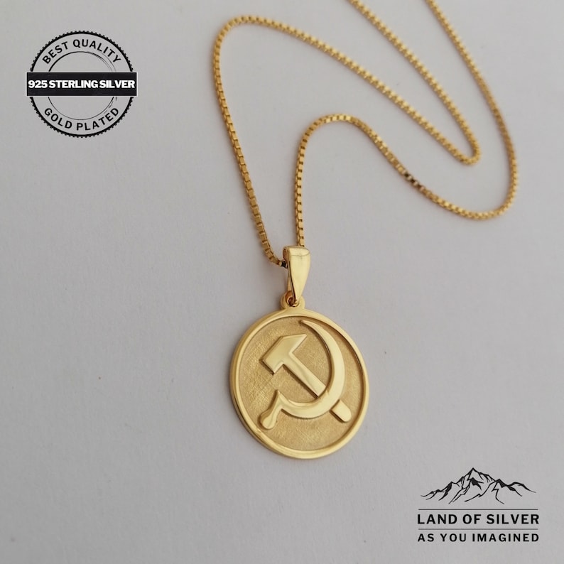 May include: Gold-plated 925 sterling silver necklace with a round pendant featuring a hammer and sickle symbol. The necklace is on a white background. "Best Quality 925 Sterling Silver Gold Plated" is written on a circular label in the top left corner of the image.