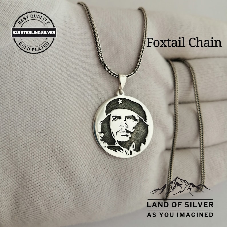 May include: A silver necklace with a round pendant featuring a profile portrait of a man with a star on his hat. The necklace is on a white surface and the text "Foxtail Chain" is visible in the image. The text "BEST QUALITY 925 STERLING SILVER GOLD PLATED" is also visible in the image. The text "LAND OF SILVER AS YOU IMAGINED" is also visible in the image.