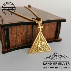 A customizable, gold-plated 925 sterling silver necklace featuring the Eye of Horus. The pendant has a triangular design containing an eye, with a small Ankh symbol at the top.