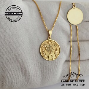 May include: Gold-plated 925 sterling silver necklace. The pendant features a moth design, a crescent moon, and foliage. The necklace has a delicate chain and a matching pendant in the upper right corner. The text "BEST QUALITY" and "GOLD PLATED" are visible.