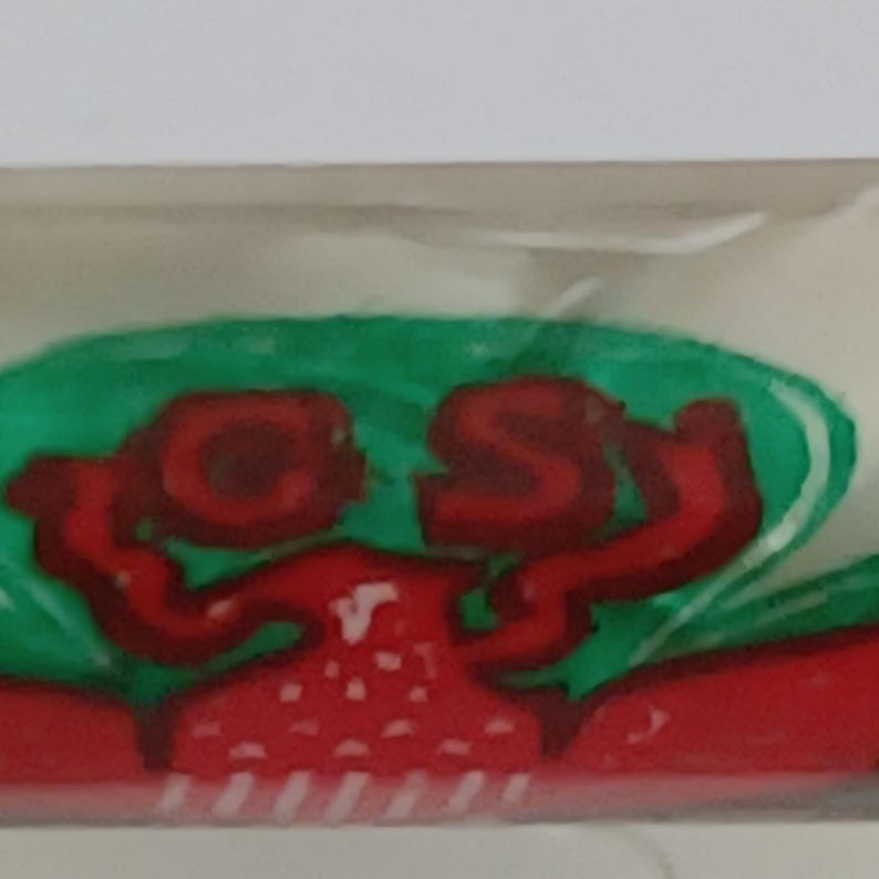 May include: A red crab-shaped design with the letters "CS" in red, outlined in a darker red. The crab is set against a green background, with a white border.