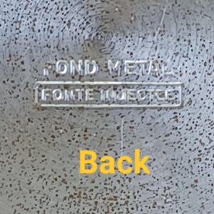 May include: Close-up of a textured, silver-colored metal surface. The words "POND METAL" are stamped at the top, with "FONTE INJECTEE" below. The word "Back" is written in yellow at the bottom.