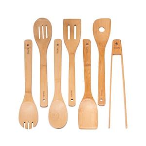 May include: A collection of seven bamboo kitchen utensils, including slotted spoons, spatulas, and tongs. The utensils are light brown with the brand name "blauke" printed on the handles. The set is arranged against a white backdrop.