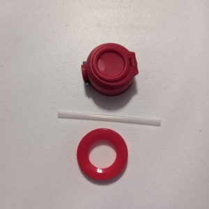 May include: Red plastic lid with a small opening, a red plastic ring, and a clear plastic straw.